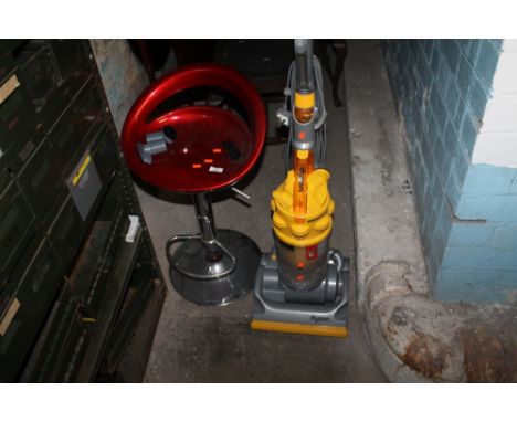 A DYSON VACCUM CLEANER TOGETHER WITH A CHROME BASED STOOL
