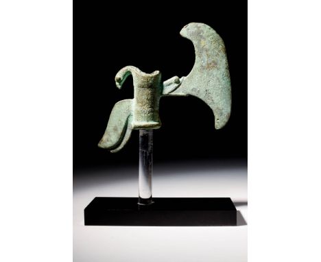 Ca. 2nd millennium BCA bronze axe head with a cylindrical socket decorated with a projecting bird's head and tail feathers, a