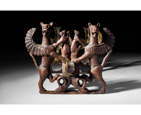 Ca. 1200 - 900 BCA Western Asiatic bronze horse bit, with two cheek pieces and a central bit. The cheek pieces are formed to 