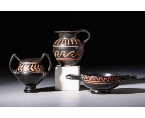 Ca. 400 - 300 BCA group of three Apulian Xenon group vessels. The first is a miniature kantharos with biconical body on a hig