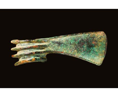 Ca. 1200 - 900 BCA Western Asiatic bronze axe head of intimidating form bearing a vertical blade edge that extends from a len