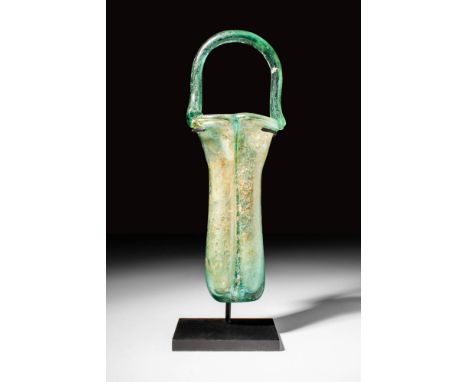 Ca. AD 400 - 500 A Roman glass balsamarium with a rounded basket handle. The body of the balsamarium contains two chambers ra