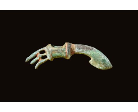 Ca. 1200 - 900 BCA Western Asiatic bronze curved axe head. The back is lined with three long spikes that were perhaps used as