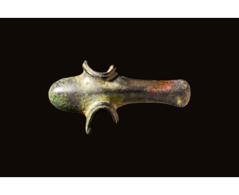 Ca. 1200 - 900 BCA Western Asiatic bronze axe head. The cylindrical socketing shaft is lined with a hemispherical hammer that