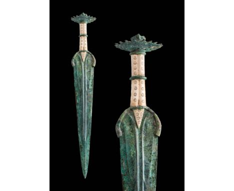 Ca. 1200 - 800 BCAn exquisite Western Asiatic / Early Greek bronze sword featuring a long, tapering double-edged blade with a