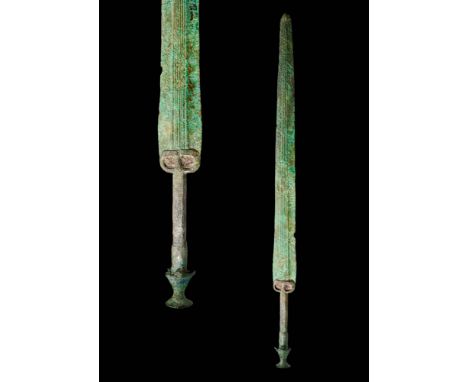 Ca. 1200 - 800 BCAn ancient bronze sword with a long, tapering blade, a prominent mid-rib composed with five lines and a grac