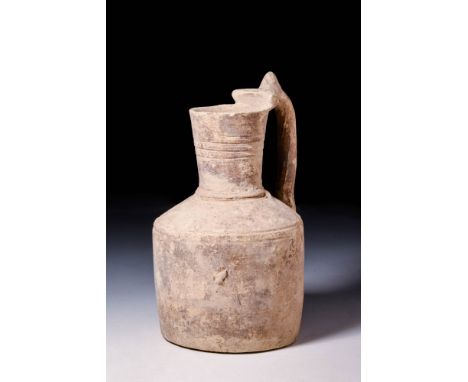 Ca. 1200 - 800 BCAn Amlash hand-built creamware pottery jug of cylindrical form with a flat base, narrow neck, vertical rim, 