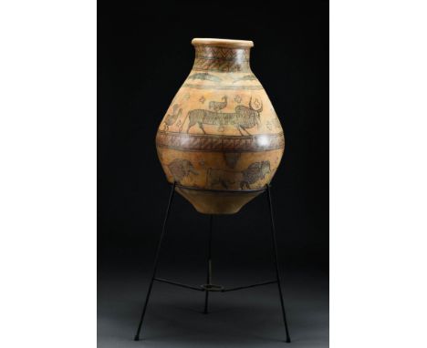 Ca. 300 - 2500 BCA large ceramic vessel, with a piriform body and tapering flat base, a cylindrical neck finished with a roun