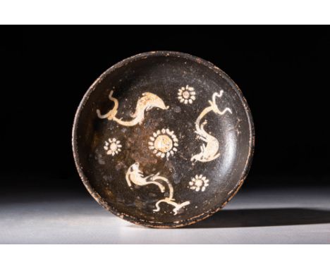 Ca. 320 - 280 BCA Gnathian wheel-thrown pottery bowl with a squat foot and a hemispherical basin, all enrobed in lustrous jet