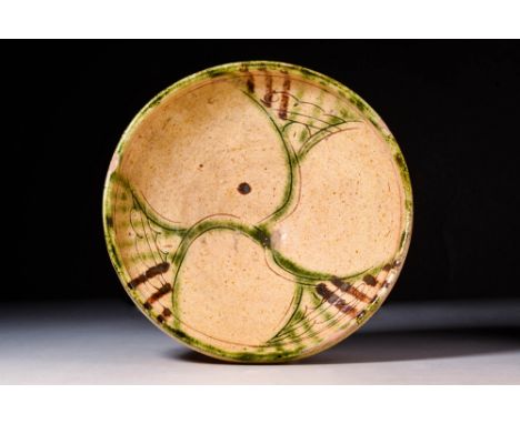 Ca. AD 900 - 1100A Nishapur pottery bowl sitting upon an unglazed high foot with a deep basin, all enveloped in a creamy whit