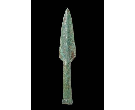 Ca. 1200 - 800 BCA Bronze Age spearhead featuring a leaf shaped blade with a slightly raised midrib, leading to a long socket