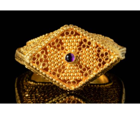 Ca. AD 900 - 1200A Byzantine openwork Bishop gold ring with a round hoop and a high bezel. The bezel is set with a cabochon g