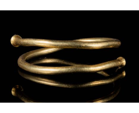Ca. 600 - 400 BCA Celtic gold ring composed of two rounds of a single gold tubular thread with pointed finials. It is an exam