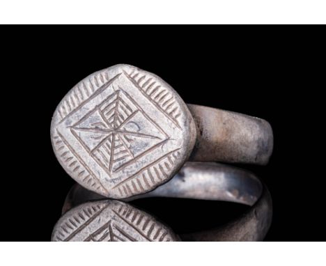 Ca. AD 1200 - 1400A medieval silver ring with a large bezel engraved with the star of Bethlehem. This is a recurring motif in