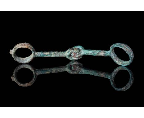 Ca. 600 BCA Celtic bronze horse bit composed of two parts connected by two rings. The other two rings are on the external edg