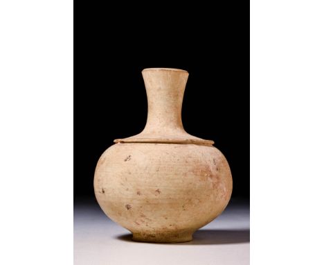 Ca. 1200 - 800 BCAn Amlash hand-built redware pottery jar of spherical form with a circular flat base, a narrow neck, and a v
