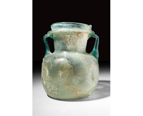 Ca. AD 300 - 500A Roman glass bottle presenting stunning pale blue hues. It's rectangular body was most likely mould-blown to