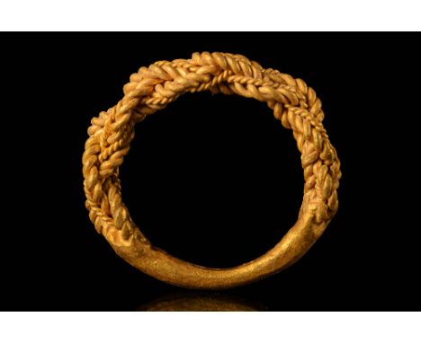 Ca. AD 800 - 1100A Viking gold ring made of twisted and braided gold wires of different dimensions that taper a solid gold ba