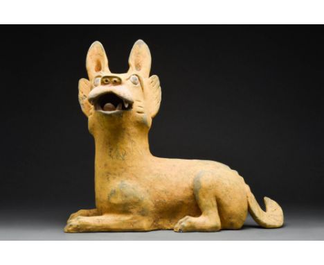 Han Dynasty, Ca. 202 BC - AD 220A fine Chinese terracotta dog. The recumubent figure is depicted in a content state, with the