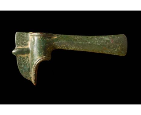 Ca. 1200 - 900 BC A Western Asiatic miniature bronze axe head. The blade is undecorated, but the butt features a flange, and 
