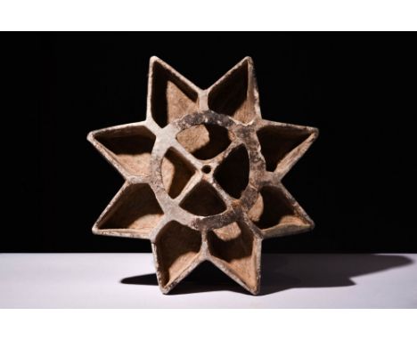 Ca. 2000 - 2000 BCA rare stone oil lamp with an eight-pointed star shape. At the top, a central circle stands out as a focal 
