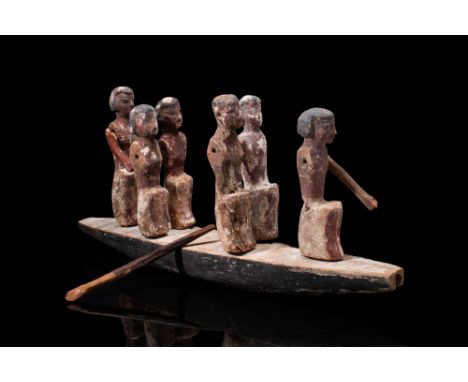 Ca. 2030 -1640 BCAn Egyptian carved and painted wooden boat with six boatmen. The men at the front and rear ends of the vesse