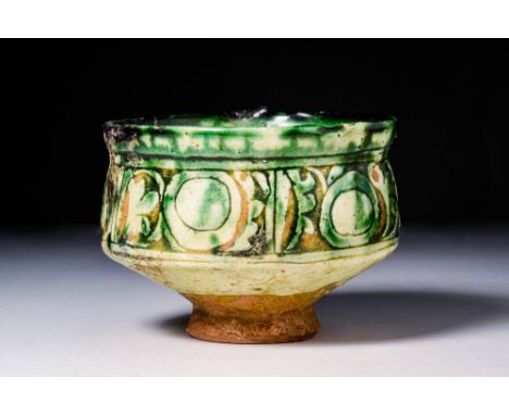Ca. AD 1100 - 1300A Byzantine Sgraffito pottery bowl sitting upon an unglazed high foot with a deep basin, all enveloped in c