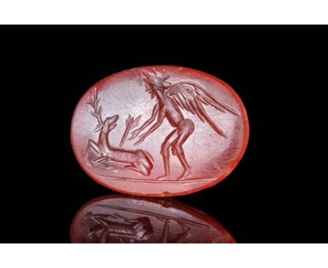 Ca. AD 100 - 300 A Roman carnelian oval intaglio depicting a narrative scene in which Eros hunts a deer with the arrow still 
