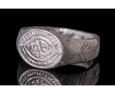 Ca. AD 900 - 1100 A Viking silver ring with an wide flat band. The exterior is convex and decorated with geometric motifs, th