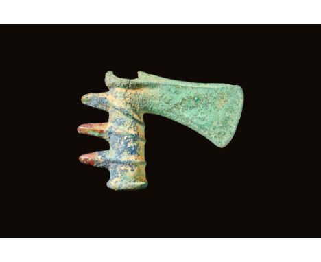 Ca. 1200 - 900 BCA Western Asiatic bronze axe head bearing a vertical short blade edge that extends from a lengthy neck. Laye