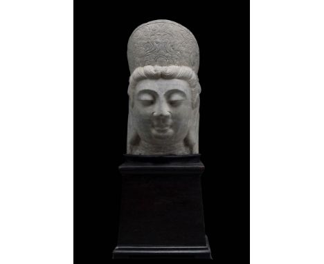 Ca. AD 619 - 906A large schist head of Guanyin Buddha. The serene face composes of heavily lidded eyes and angular nose, the 