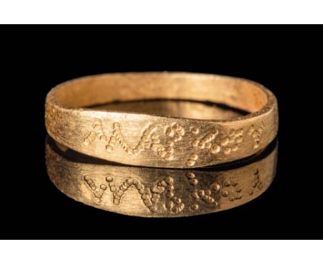 Ca. AD 100 - 300A Roman gold ring with band shaped hoop, flat section widening to form an elongated belzel incised with dots 