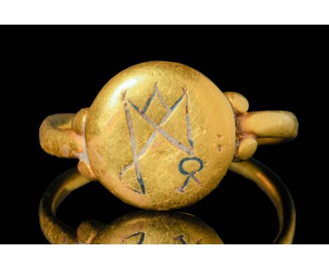 Ca. AD 500 - 700A stunning Merovingian gold ring with a slender hoop. The bezel is connected with two gold pellets on each si