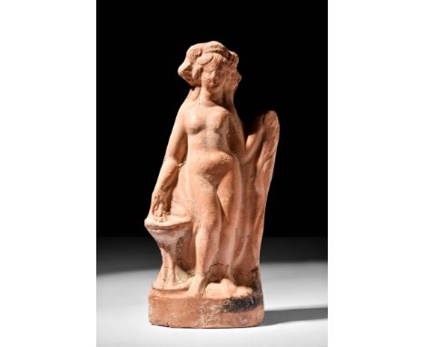 Ca. 350 BCA terracotta, moulded pottery statuette of Aphrodite. The goddess stands nude, her head adorned with a flowery wrea