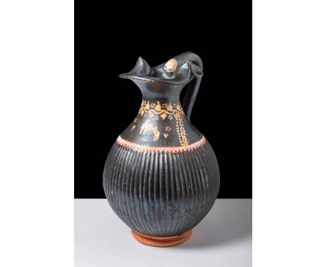 Ca. 340 - 300 BCAn elegant Gnathian ware ribbed Oinochoe pottery pitcher with a trefoil spout decorated with red, white, and 