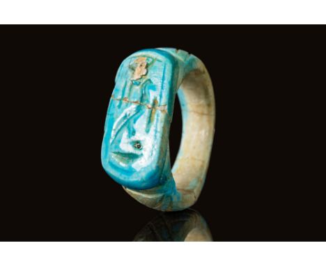 Third Intermediate Period, Ca. 750-654 BCAn Egyptian bright blue faience finger ring with a flat bezel bearing a hieroglyphic