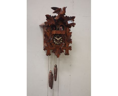 German wall hanging cuckoo clock, with revolving figural platform, carved with bird and leaves, H37cm  CLOCKS & BAROMETERS - 