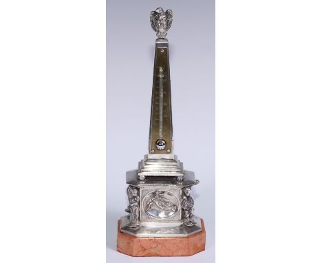 An early 20th century silvered obelisk desk thermometer, eagle finial, the friece with bas relief and figures allegorical of 