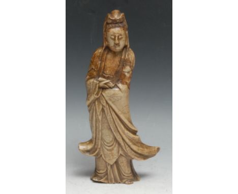 A Chinese soapstone figure, carved as Guanyin, she stands, holding a scroll, 26cm high, 19th century 