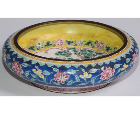 A Chinese famille rose enamel bowed circular bowl, painted in the typical Cantonese manner with ladies of the court, on a yel