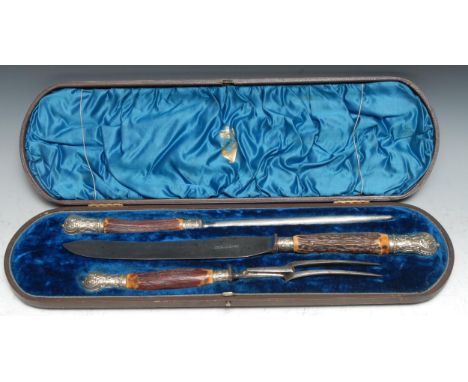 A Victorian three piece carving set, comprising knife, fork and steel, by Henry Clegg &amp; Sons, Sheffield, stag antler haft