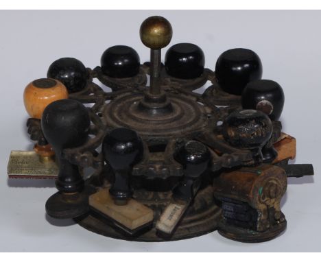 Seals - a 19th century cast iron ten-section revolving desk seal stand, brass ball finial, 17cm diam, en suite a collection o