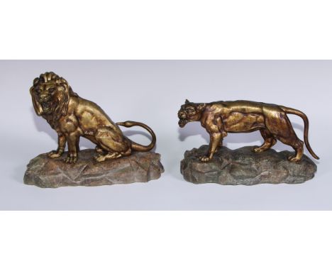 Aubert (French), a pair of gilt bronzes, lion and lioness, each snarling, rocky marble bases, the lion signed to base, he 21c