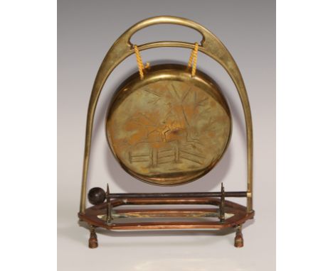 A Victorian brass and copper novelty table top dinner gong, of equestrian interest, as an oversize stirrup, the gong engraved