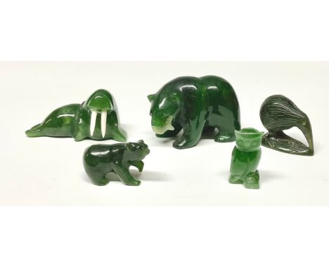 A nephrite carving of a bear holding a fish, 5cm wide; another; a kiwi; an owl; a walrus (5) 