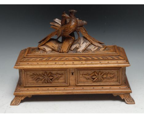 A Black Forest rectangular box, hinged cover surmounted by a pair of pheasants, the interior lined in deep button rose silk, 