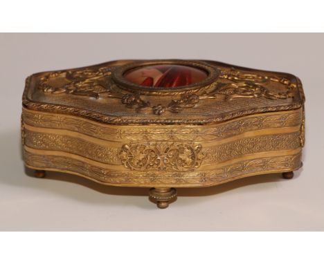 A Continental gilt metal quatrefoil casket, the hinged cover centred by a porcelain plaque, decorated with a bust length prof