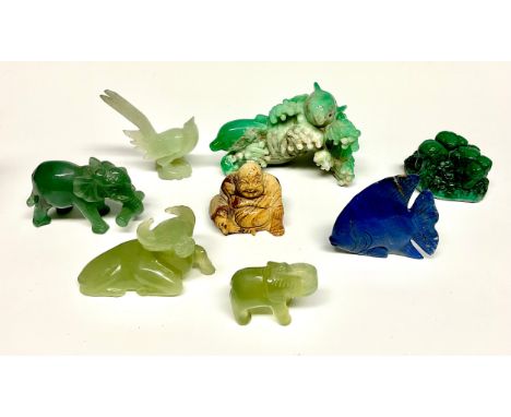 A Chinese malachite scholar's carving, of a rock formation, 7cm wide; a jade carving of an ox; a lapis lazuli fish; a hardsto