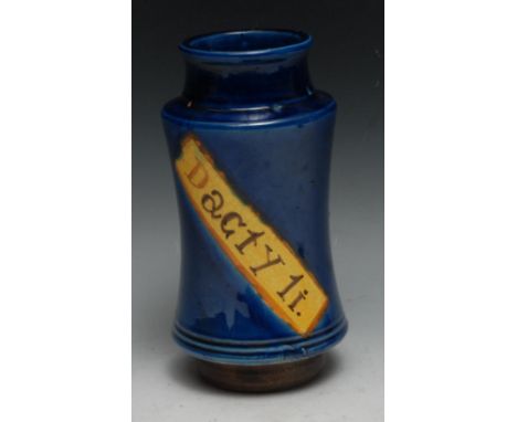 A Continental albarello drug jar, inscribed Dacty Li, within a yellow banner on a blue glazed ground, 21.5cm high, 19th centu