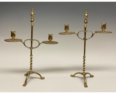 A pair of 19th century brass adjustable tripod two-light candelabra, knop finials, bell shaped sconces with broad drip pans, 